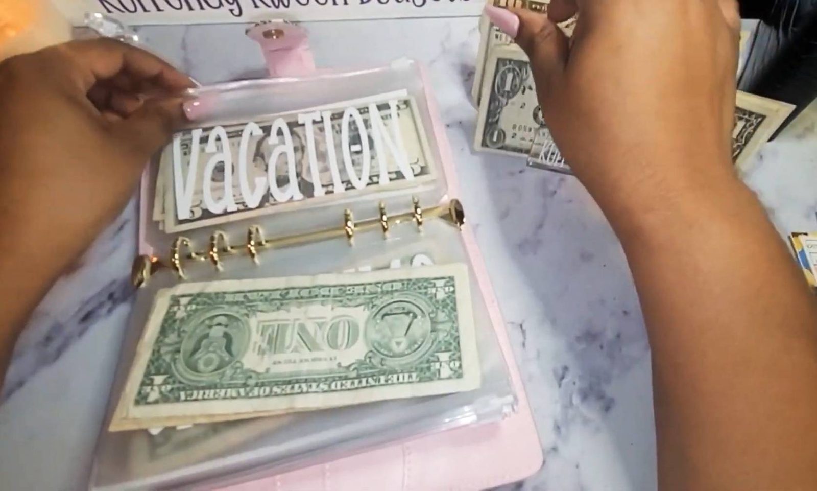 Cash sorted into labelled envelopes, an emergency-fund buffer set aside in notes